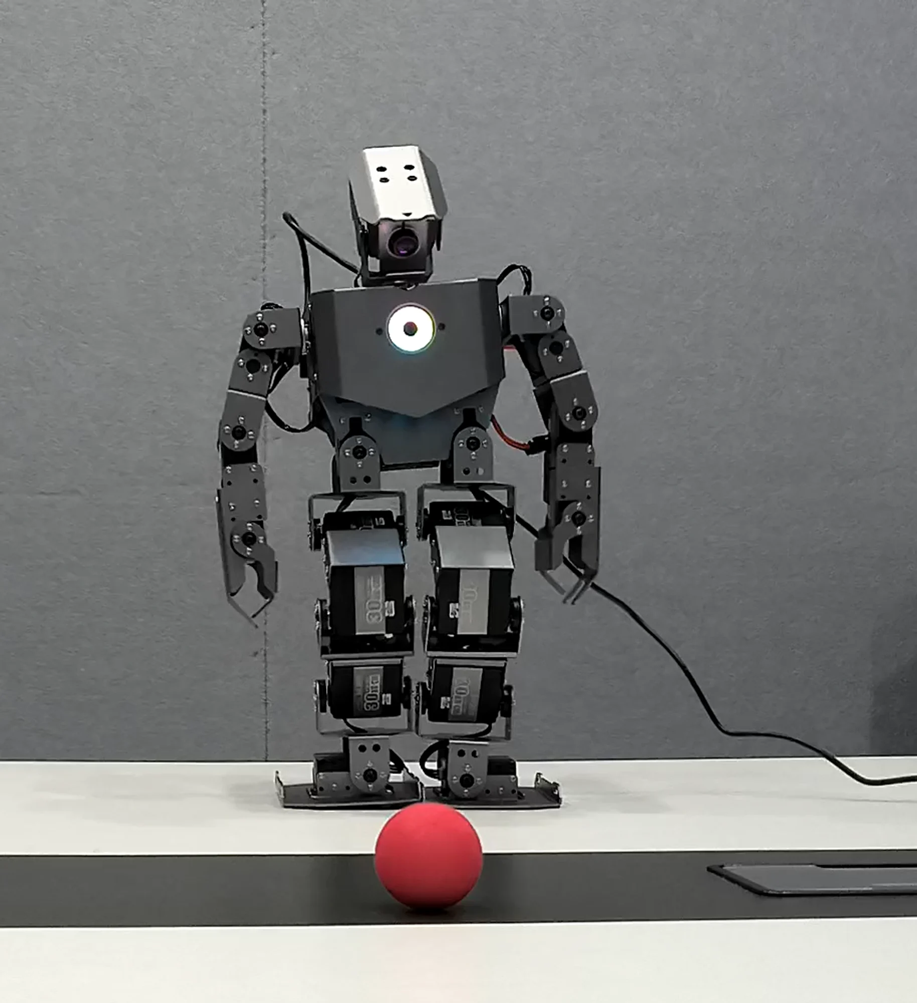 OriginMan humanoid robot tracking a ball
